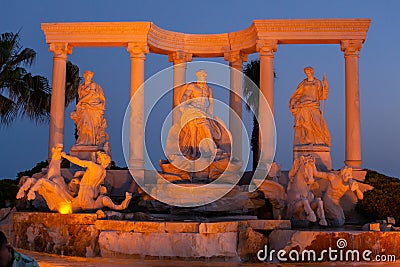 Antalya, Turkey - May, 2021: The symbol of the Alva Donna Exclusive Hotel - statues near the pool in the evening colorful lighting Editorial Stock Photo