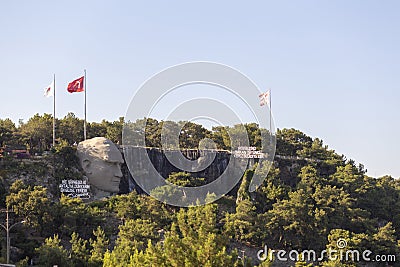 Antalya, Turkey - 03.07.2020: Statue of Mustafa Kemal Ataturk and an artificial waterfall, at the entrance to the city forest, an Editorial Stock Photo