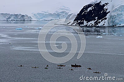 Antarctic kayakers silhouetted Stock Photo