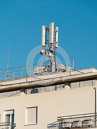 Antenna Mobile Communication on the top of a building Stock Photo