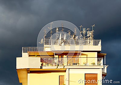 Antennas on a roof, against a cloudy sky Stock Photo