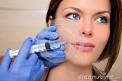 Anti aging facial mesotherapy with syringe closeup woman face Stock Photo