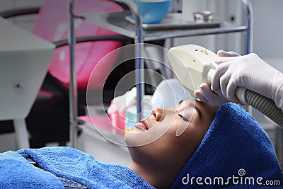 Anti Aging Facial treatment with Cream massage on woman face Stock Photo