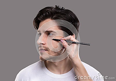 Plastic surgeon drawing guide marks on male patient face Stock Photo