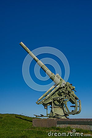 Anti-aircraft gun on a granite pedestal, on the background of sky Stock Photo