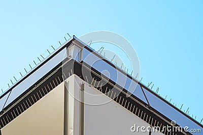 Anti-Bird Spikes on Parapet of Modern Building Stock Photo