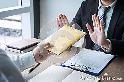 Anti bribery and corruption concept, Business man refusing and don`t receive money banknote in envelope offer from business peopl Stock Photo