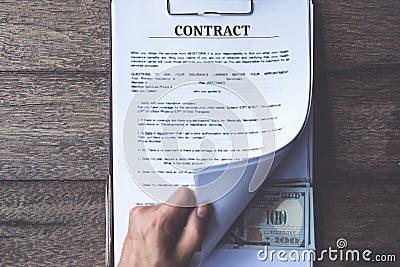 Anti bribery and corruption concepts, money offered in file, giving money in file while making deal to agreement Stock Photo