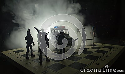 Anti-riot police give signal to be ready. Government power concept. Police on chessboard. Smoke on a dark background with lights. Stock Photo