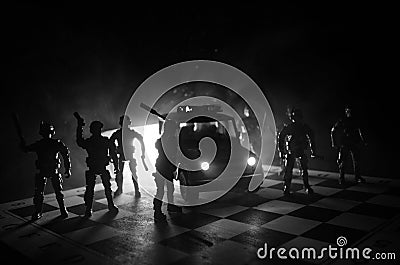 Anti-riot police give signal to be ready. Government power concept. Police on chessboard. Smoke on a dark background with lights. Stock Photo