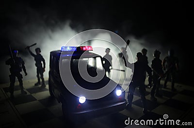 Anti-riot police give signal to be ready. Government power concept. Police on chessboard. Smoke on a dark background with lights. Stock Photo