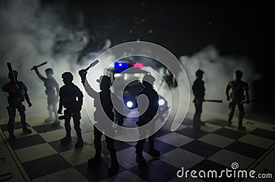 Anti-riot police give signal to be ready. Government power concept. Police on chessboard. Smoke on a dark background with lights. Stock Photo