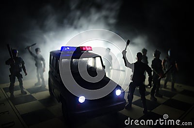 Anti-riot police give signal to be ready. Government power concept. Police on chessboard. Smoke on a dark background with lights. Stock Photo