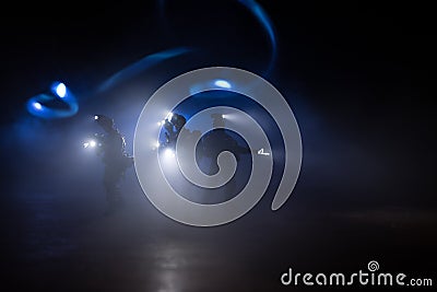 Anti-riot police give signal to be ready. Government power concept. Police in action. Smoke on a dark background with lights. Blue Stock Photo