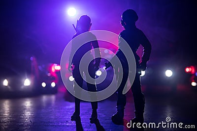 Anti-riot police give signal to be ready. Government power concept. Police in action. Smoke on a dark background with lights. Blue Stock Photo