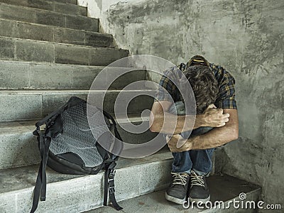 Campaign vs homophobia with young sad and depressed college student man sitting on staircase desperate victim of harassment Stock Photo