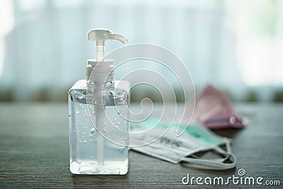 Antibacterial transparent hand sanitizer gel in a plastic bottle with surgical mask corona virus covid-19 text written Stock Photo