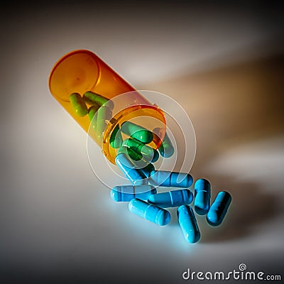 Pharmaceutical pills pouring out of a bottle Stock Photo