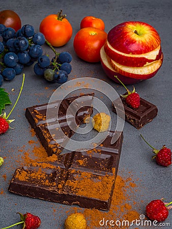 anticancer food, good for cardiovasculas system, fresh ripe grape, dark chocolate, raspberries, tomatoes, apple on concrete Stock Photo