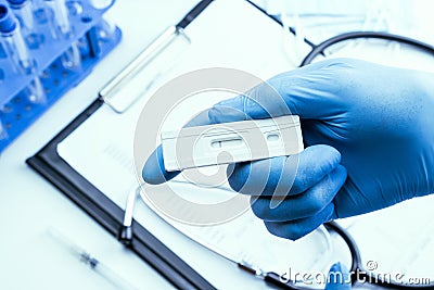 Antigen test antigen coronavirus kit. Laboratory hospital lab background. Doctor holding rapid covid medical test Stock Photo