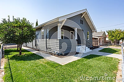 A newly remodeled house with green grass and a blue sky Editorial Stock Photo