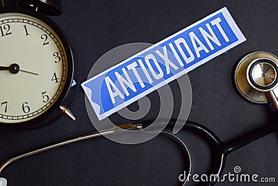 Antioxidant on the paper with Healthcare Concept Inspiration. alarm clock, Black stethoscope. Stock Photo