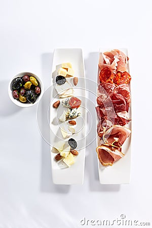 Antipasti on plates top view Stock Photo