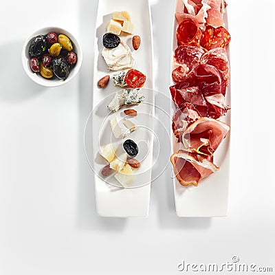 Antipasti on plates top view Stock Photo