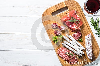 Antipasto delicatessen - meat, ham and wine on white. Stock Photo