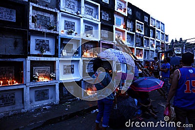 People go to cemeteries and visit their dead family members in a two day traditional annual celebration for the dearly departed Editorial Stock Photo