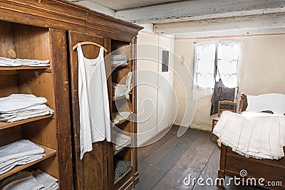 Antiquated bedroom with linen clothing Stock Photo