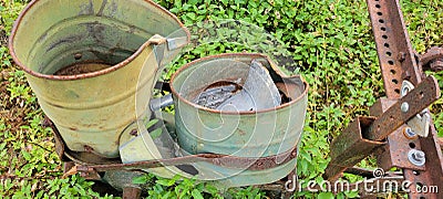 Antique aluminum bucket farm seeder Stock Photo