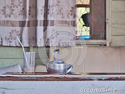 Antique Aluminum Kettle and empty glass with tube. Stock Photo