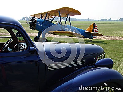 Antique Boeing Stearman PT-17 and 1940s Roadster Editorial Stock Photo