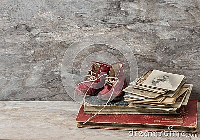 Antique books, photos, and baby shoes. Nostalgic still life Stock Photo