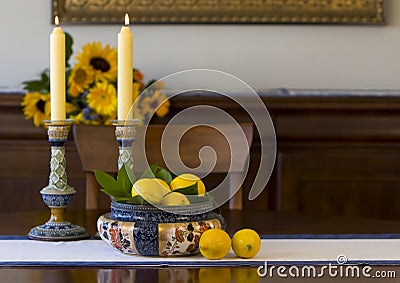 Antique bowl, candlesticks, lemons Stock Photo