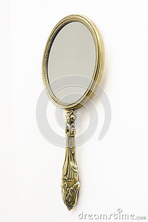 Antique brass hand-mirror Stock Photo