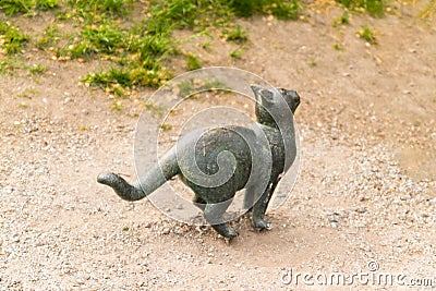 Antique bronze resting cat monument on the street. Metal figure of a cat in Stogkolm Stock Photo