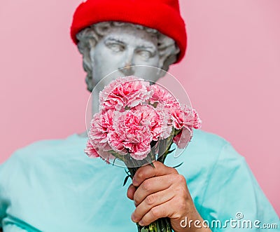 Antique bust of male in hat with carnations bouquet Stock Photo