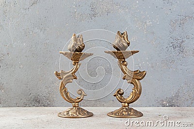 Antique candlesticks on concrete background Stock Photo