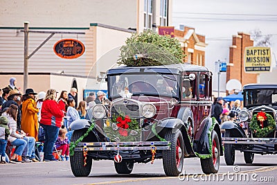Antique car driving in Cowboy Christmas Parade Editorial Stock Photo