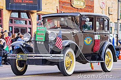 Antique car driving in Cowboy Christmas Parade Editorial Stock Photo