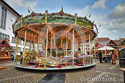 Antique carousel as part of traditional Christmas market at university square in Heidelberg city center Editorial Stock Photo