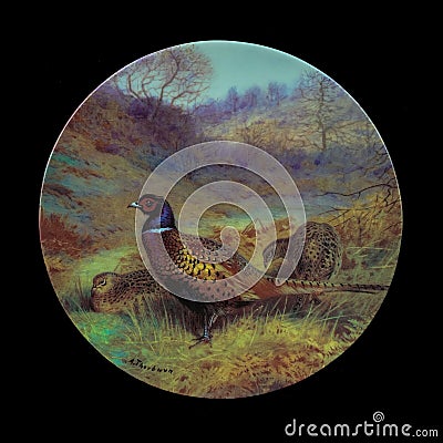 Antique ceramic plate with the image of birds. Editorial Stock Photo