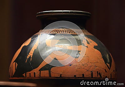 Antique ceramic red-figure psykter depicting a reclining woman with a bowl in her hand during a symposium, close-up Editorial Stock Photo
