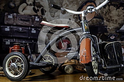 antique children's peddle tricycle in attic Stock Photo