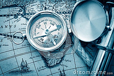 Antique compass, magnifier, spyglass on map Stock Photo