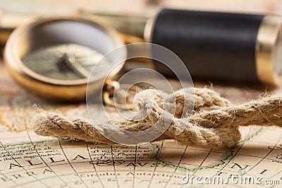 Antique compass, magnifier, spyglass on map Stock Photo