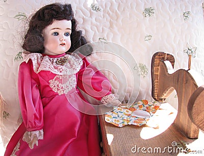 Antique Doll with her Sewing Machine Stock Photo