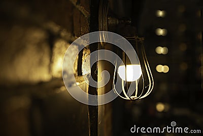 Antique electronic lamp, hanging at the red brick wall in the building.soft focus Stock Photo